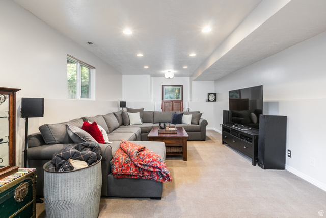 10183 Hickory Point Drive Sandy, UT 84092 - Photo 24 of 36 Spacious lower-level area featuring recessed lighting, a large window, light-toned carpeting, and a two-tone wall treatment