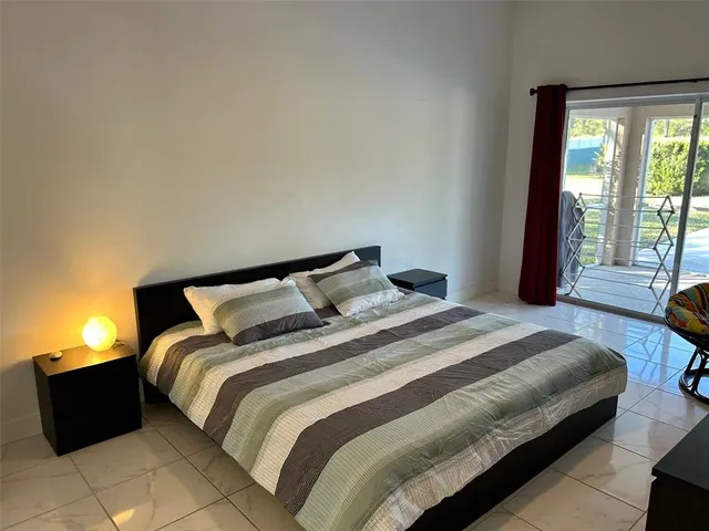 a bedroom with a bed and flat screen tv