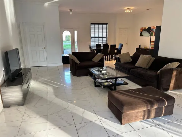 a living room with furniture and a lamp