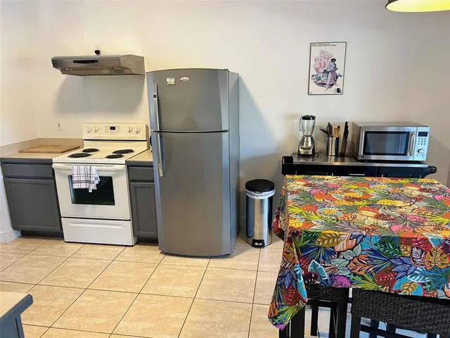 a kitchen with stainless steel appliances granite countertop a refrigerator and a stove