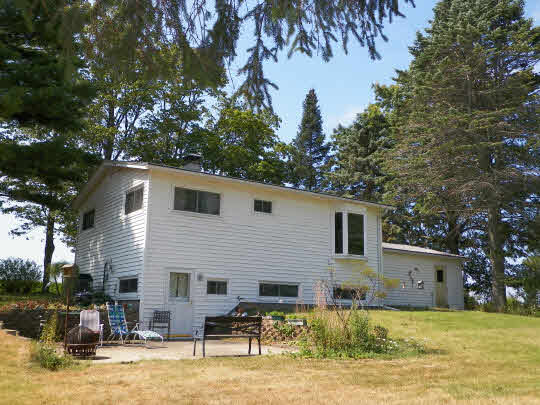 9065 Cunningham Road Winnebago, IL 61088 - Photo 2 of 6 a backyard of a house with large trees and outdoor seating