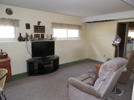 9065 Cunningham Road Winnebago, IL 61088 - Photo 3 of 6 a living room with furniture and a flat screen tv
