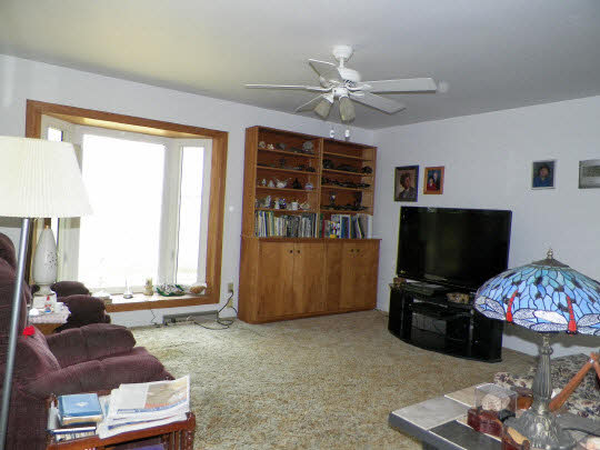 9065 Cunningham Road Winnebago, IL 61088 - Photo 6 of 6 a living room with furniture and a flat screen tv