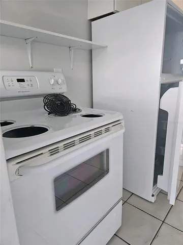 a close view of stove top oven and cabinets