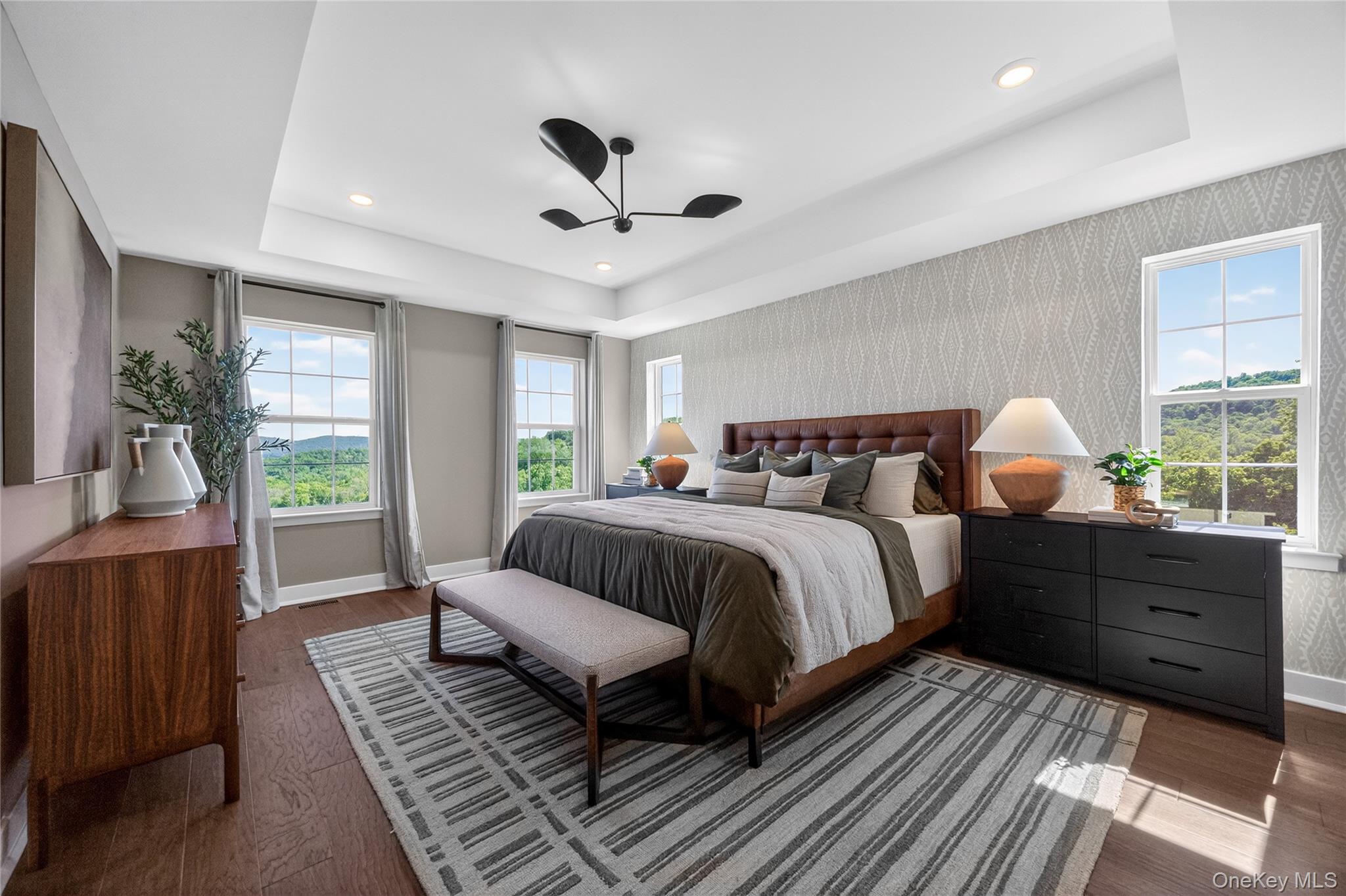 101 Pine Ridge Road Tuxedo Park, NY 10987 - Photo 17 of 26 Spacious primary bedroom featuring a tray ceiling.