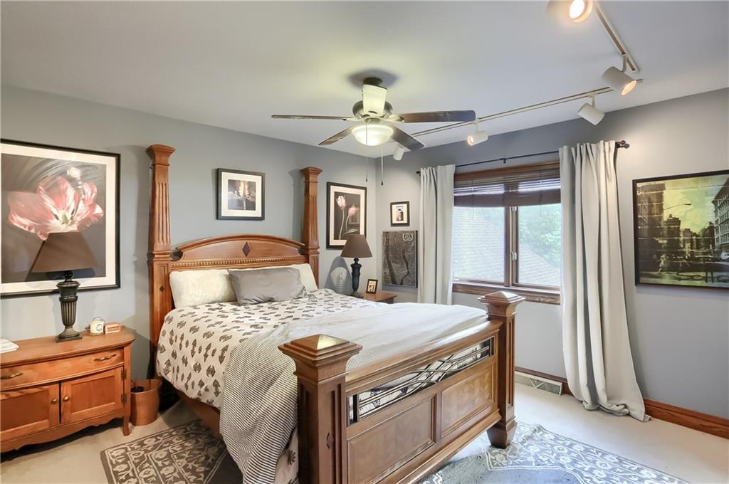325 Overbrook Road Valencia, PA 16059 - Photo 31 of 34 a bedroom with a bed and a chandelier