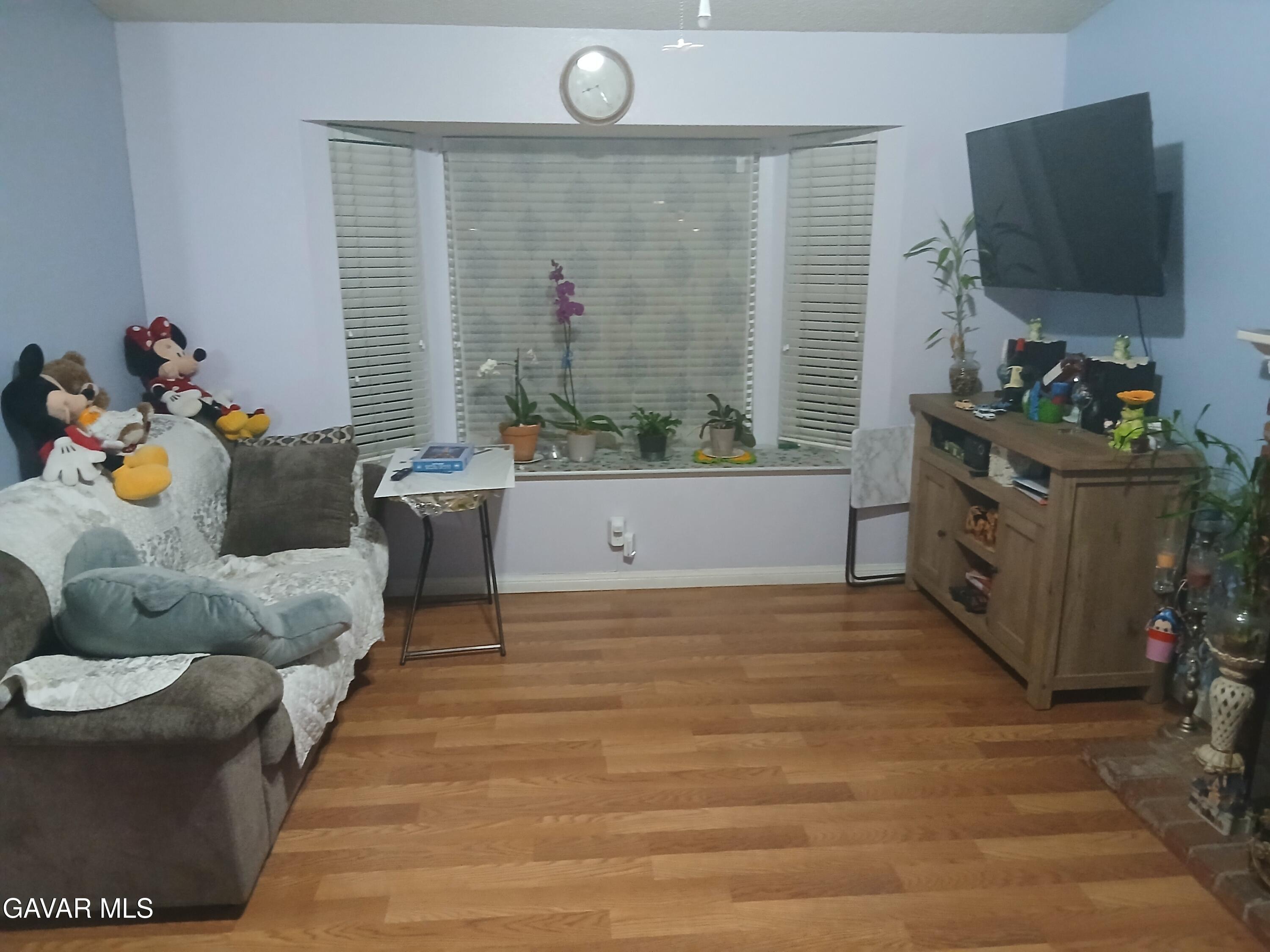 4111 Saddleback Road Palmdale, CA 93552 - Photo 15 of 23 a living room with furniture and a flat screen tv
