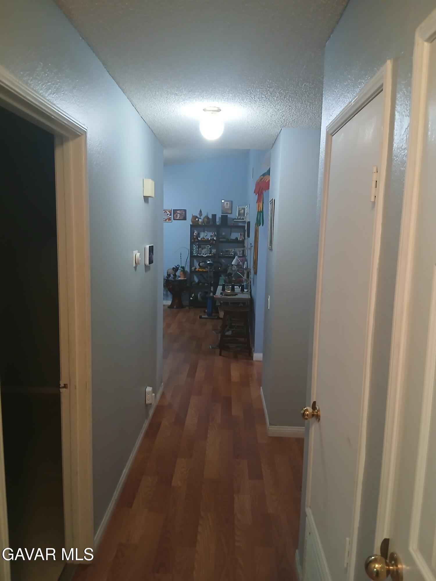 4111 Saddleback Road Palmdale, CA 93552 - Photo 4 of 23 a view of a hallway with a chair