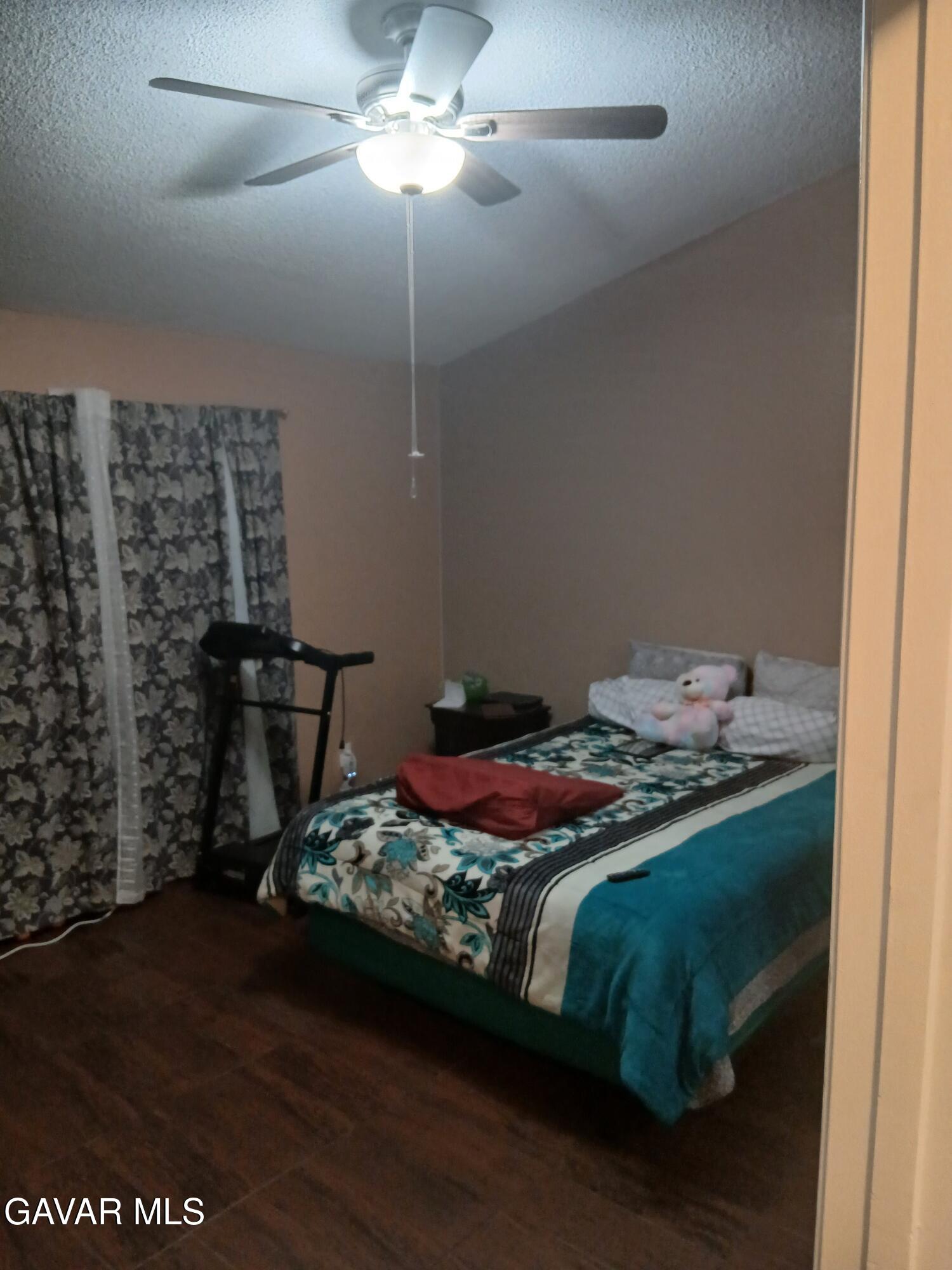 4111 Saddleback Road Palmdale, CA 93552 - Photo 5 of 23 a bed sitting in a bedroom next to a window