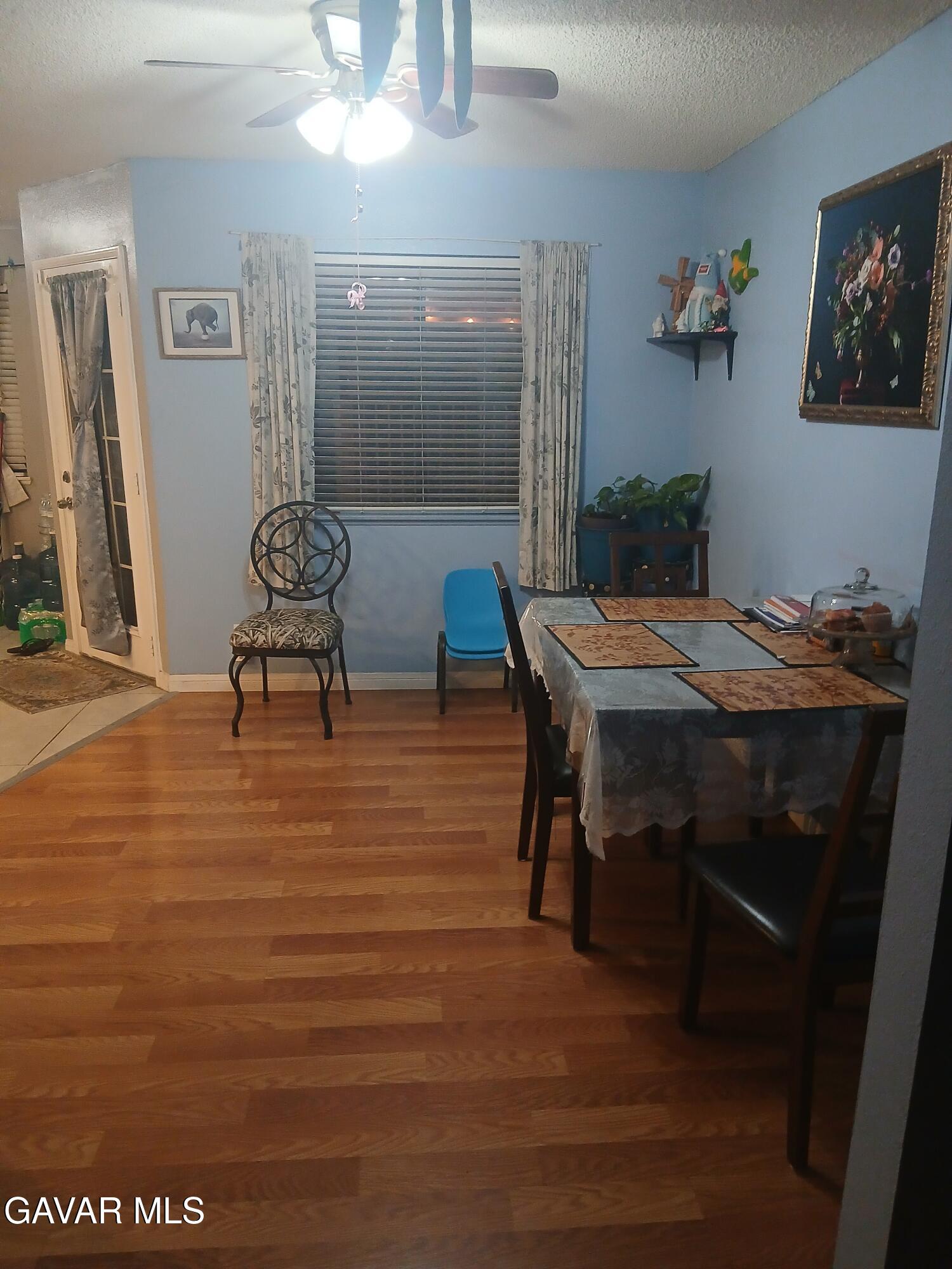 4111 Saddleback Road Palmdale, CA 93552 - Photo 6 of 23 a view of a dining room with furniture and wooden floor