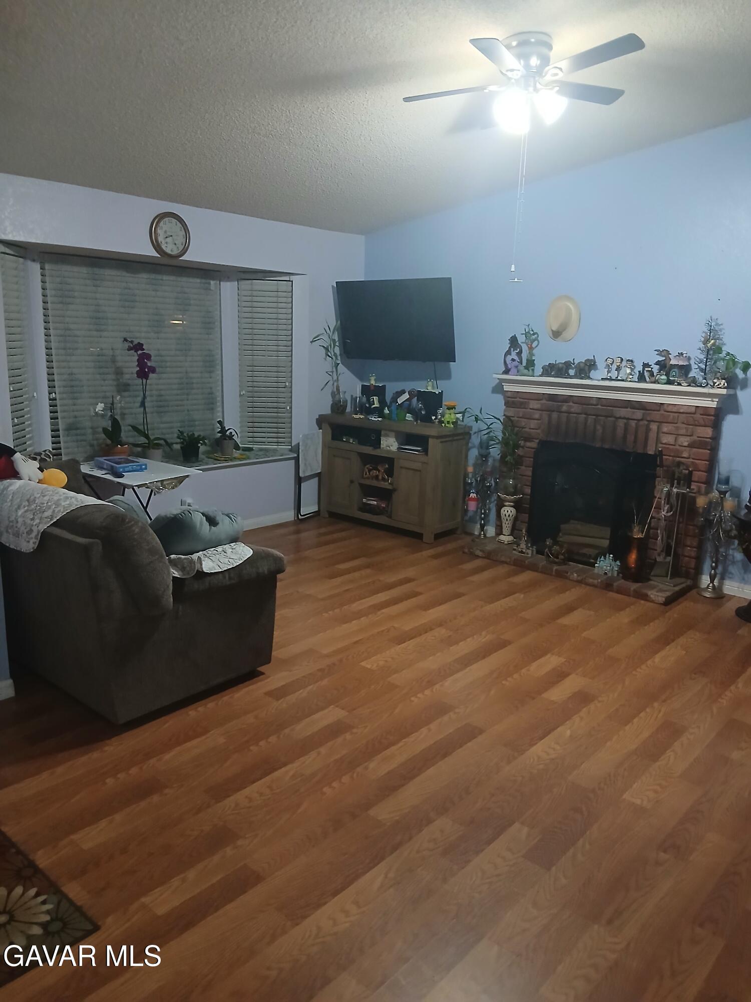 4111 Saddleback Road Palmdale, CA 93552 - Photo 8 of 23 a living room with furniture and a flat screen tv