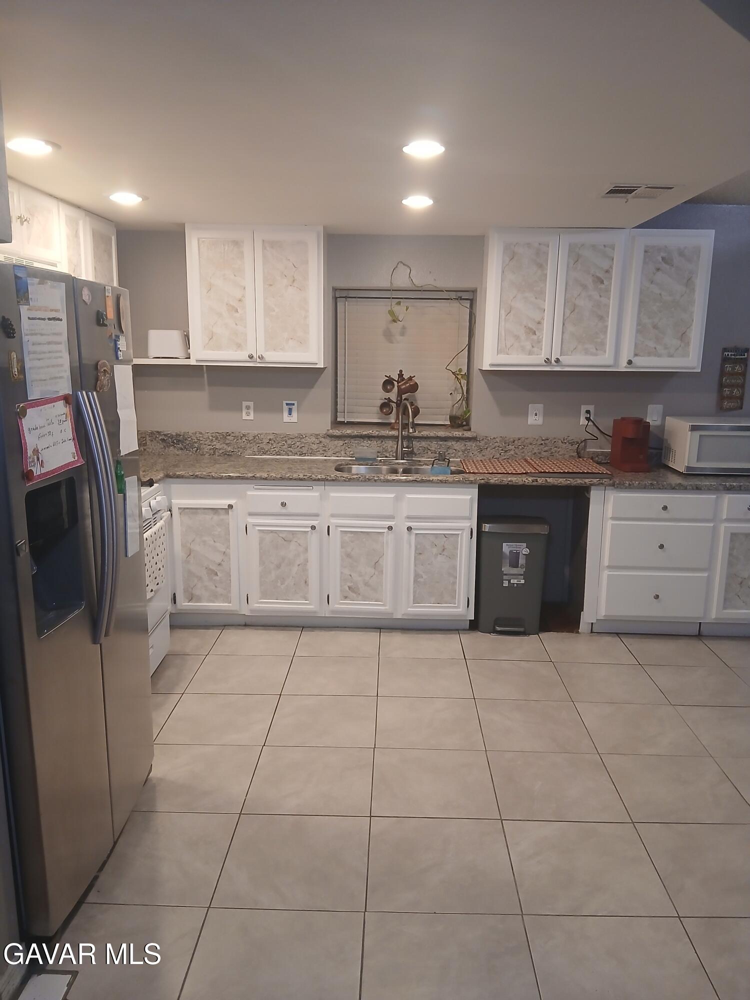 4111 Saddleback Road Palmdale, CA 93552 - Photo 9 of 23 a large kitchen with stainless steel appliances granite countertop a stove a sink and a granite counter tops