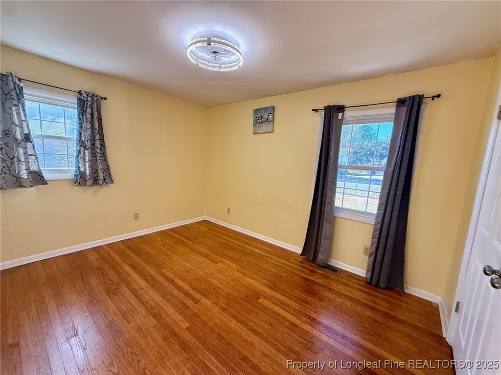 741 Newport Road Fayetteville, NC 28314 - Photo 14 of 48 a view of empty room with wooden floor and fan