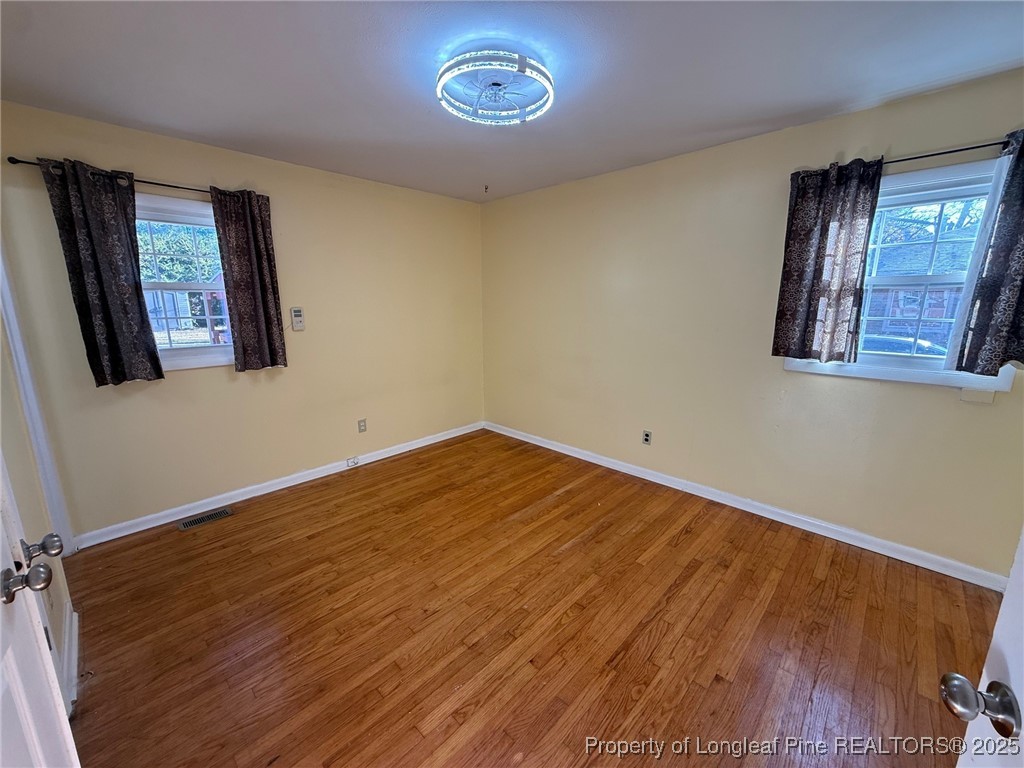 741 Newport Road Fayetteville, NC 28314 - Photo 15 of 48 a view of a room with wooden floor and window