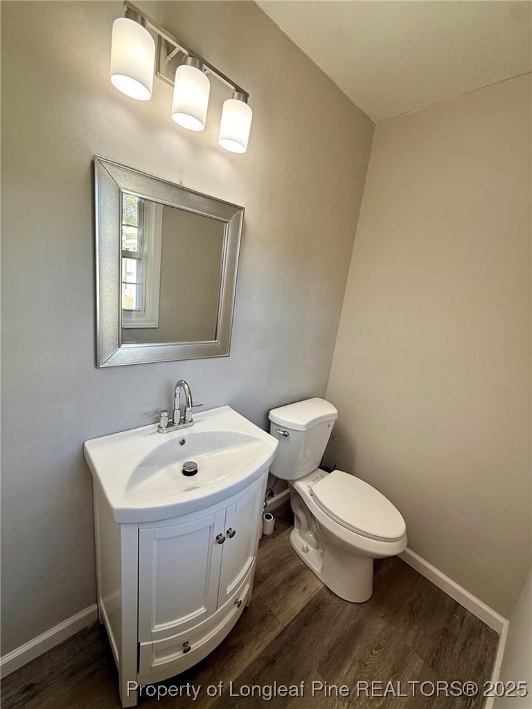 741 Newport Road Fayetteville, NC 28314 - Photo 16 of 48 a bathroom with a toilet sink and mirror