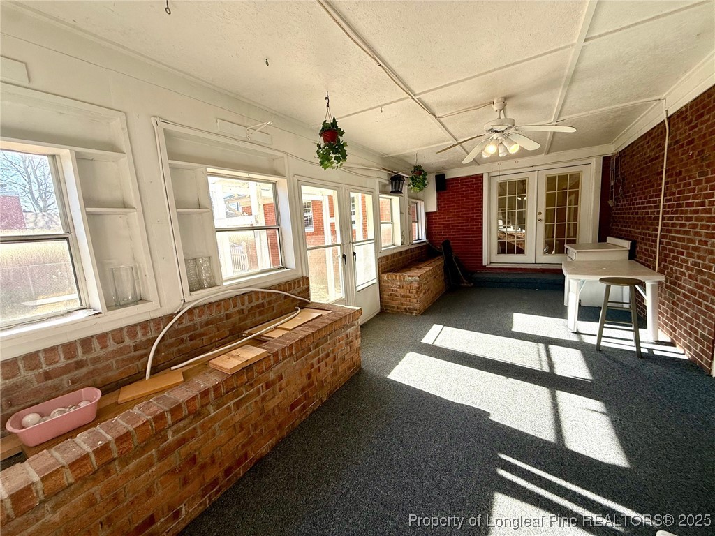 741 Newport Road Fayetteville, NC 28314 - Photo 27 of 48 a spacious bedroom with a bed wooden floor and a large window
