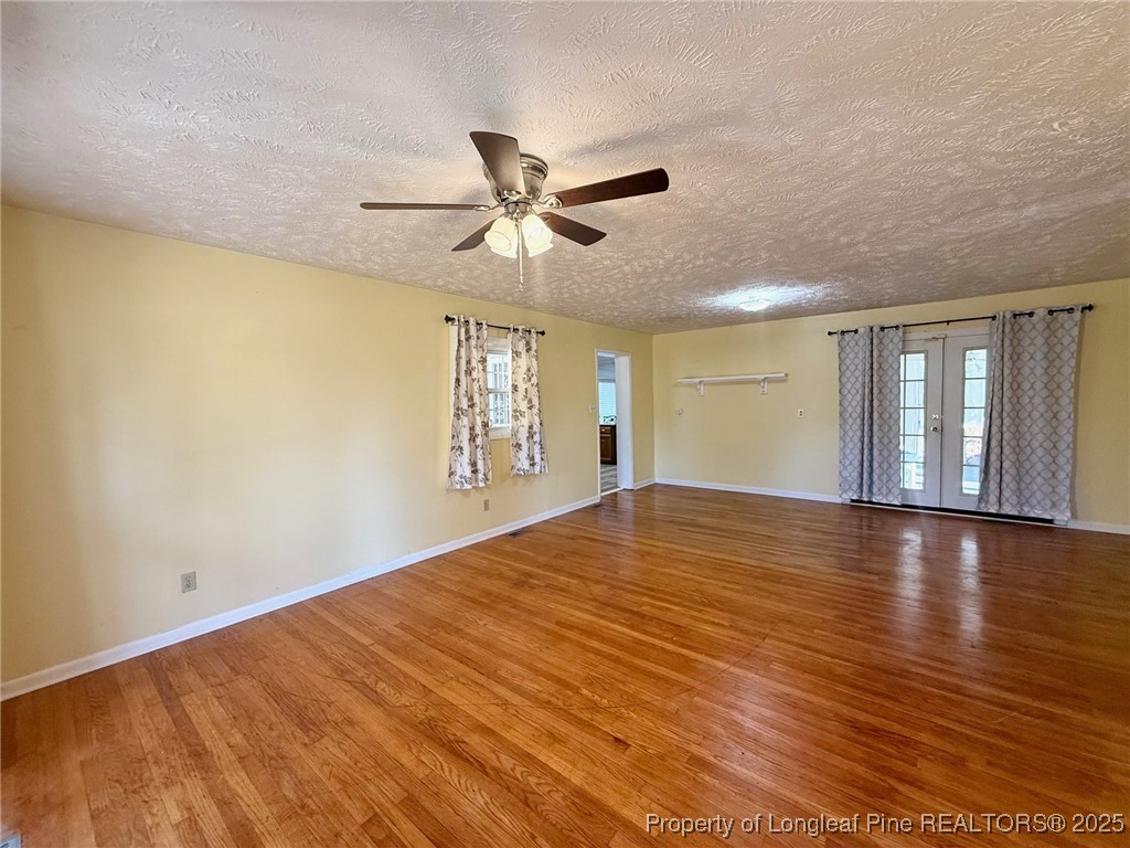 741 Newport Road Fayetteville, NC 28314 - Photo 6 of 48 a view of an empty room with window and wooden floor