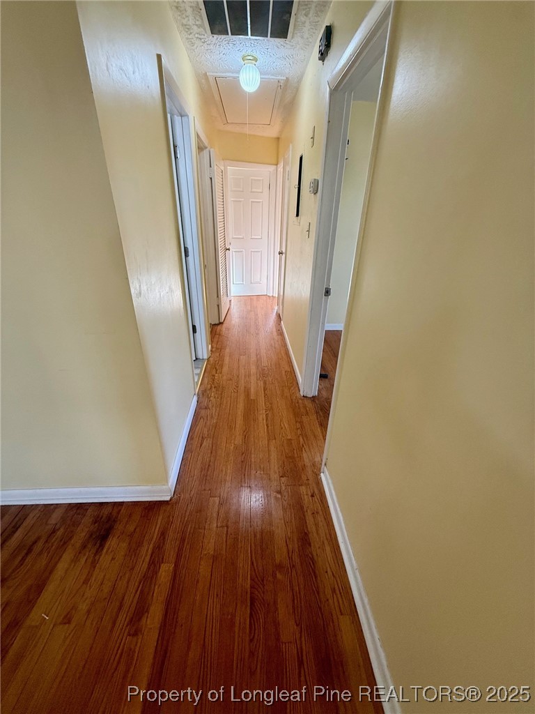741 Newport Road Fayetteville, NC 28314 - Photo 9 of 48 a view of a hallway with wooden floor and staircase