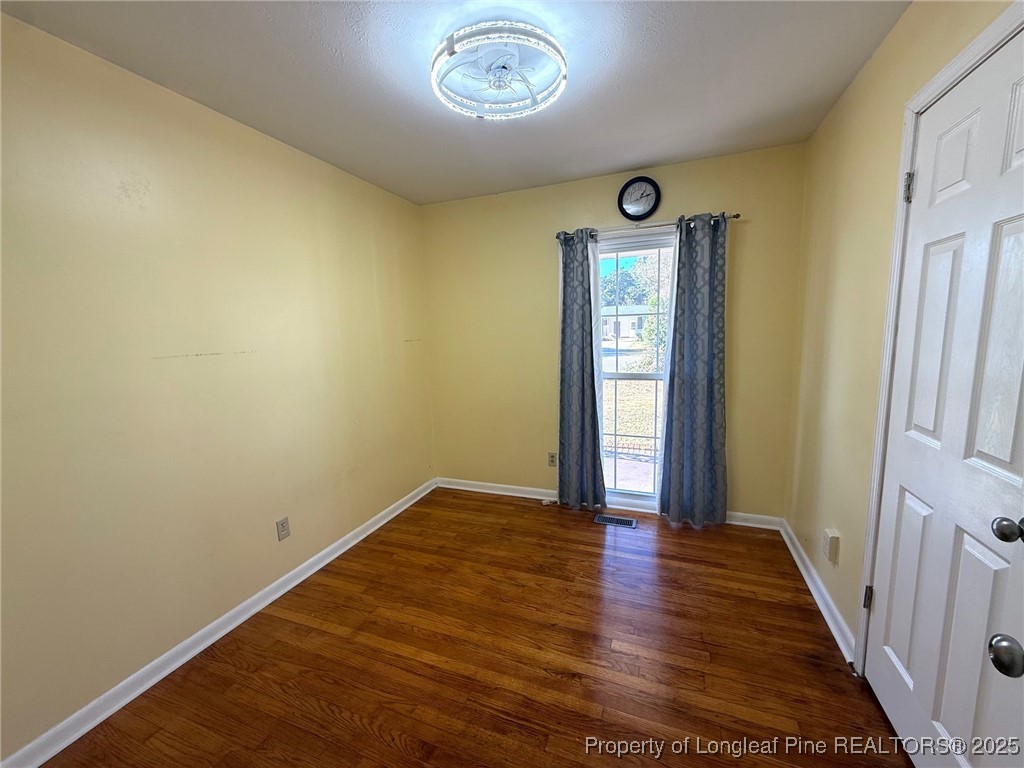 741 Newport Road Fayetteville, NC 28314 - Photo 10 of 48 a view of an empty room with wooden floor and a window