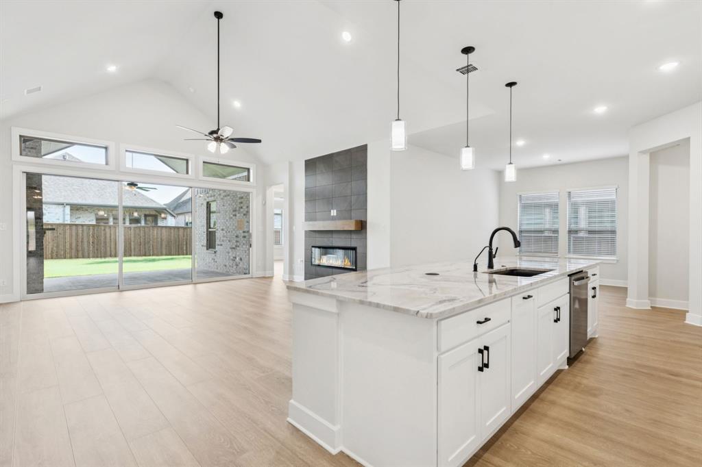 224 Bee Balm Road McKinney, TX 75071 - Photo 3 of 20 a view of a kitchen with a sink and chandelier