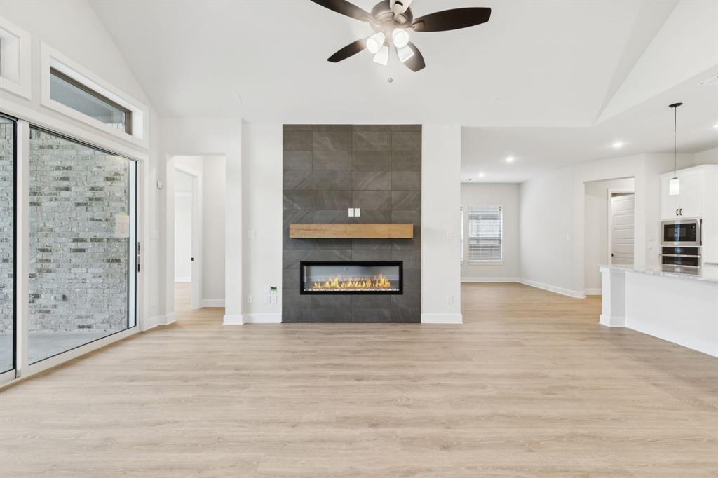 224 Bee Balm Road McKinney, TX 75071 - Photo 5 of 20 a view of an empty room with a fireplace and a window