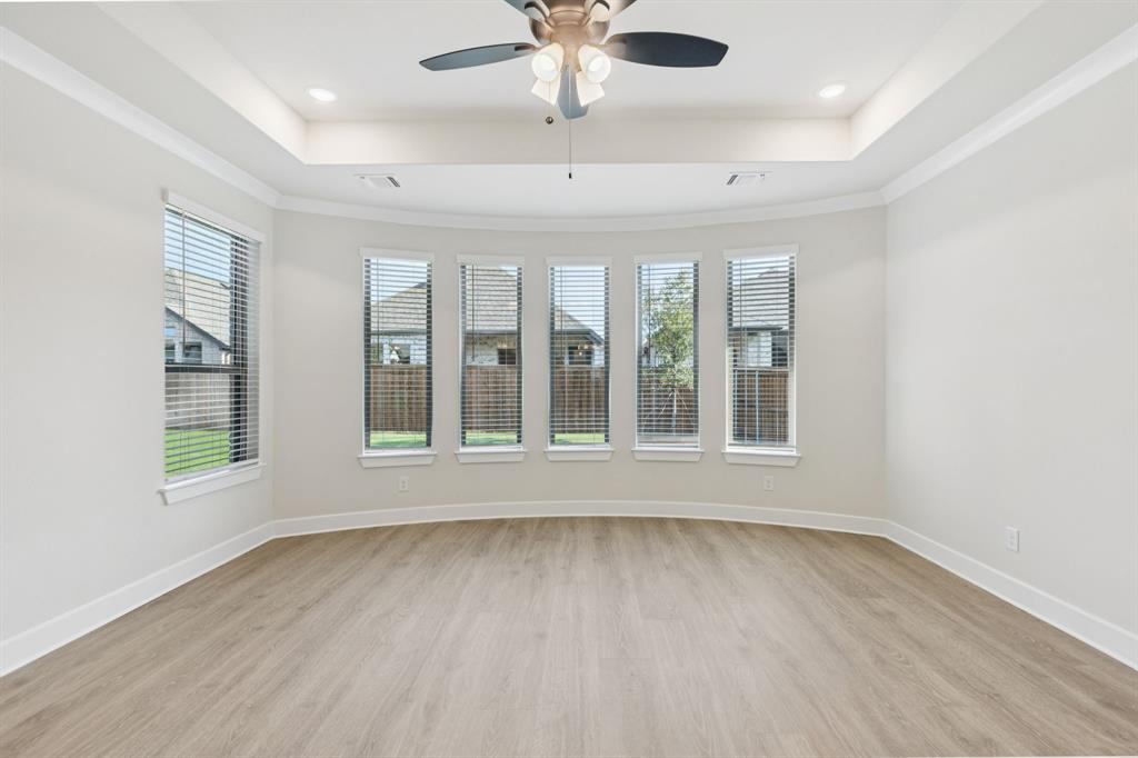 224 Bee Balm Road McKinney, TX 75071 - Photo 7 of 20 a view of an empty room with a window and wooden floor