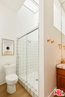 a bathroom with a toilet and a shower