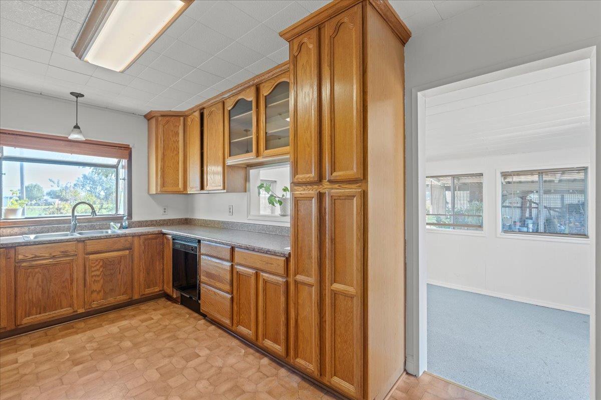 23707 North Graham Road Acampo, CA 95220 - Photo 11 of 37 a kitchen with stainless steel appliances granite countertop a refrigerator and wooden cabinets