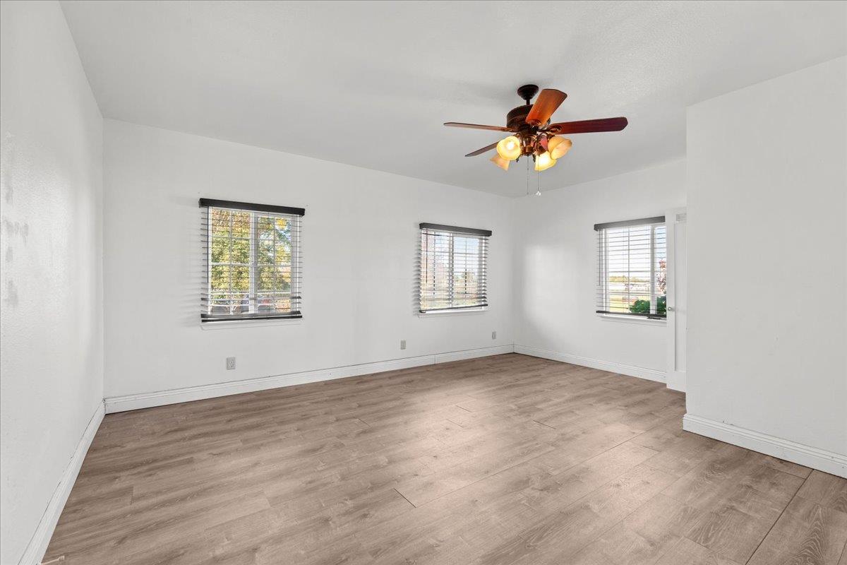 23707 North Graham Road Acampo, CA 95220 - Photo 21 of 37 an empty room that has a window and a ceiling fan