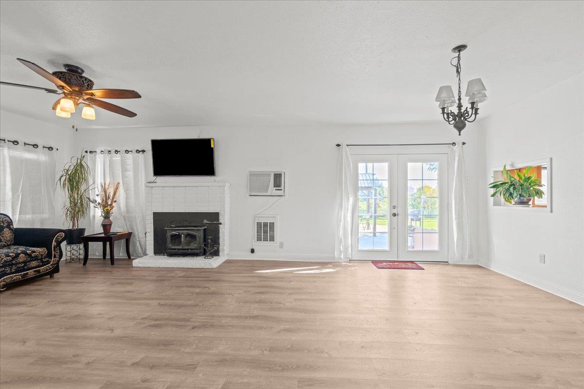 23707 North Graham Road Acampo, CA 95220 - Photo 7 of 37 a view of an empty room with a fireplace and a window