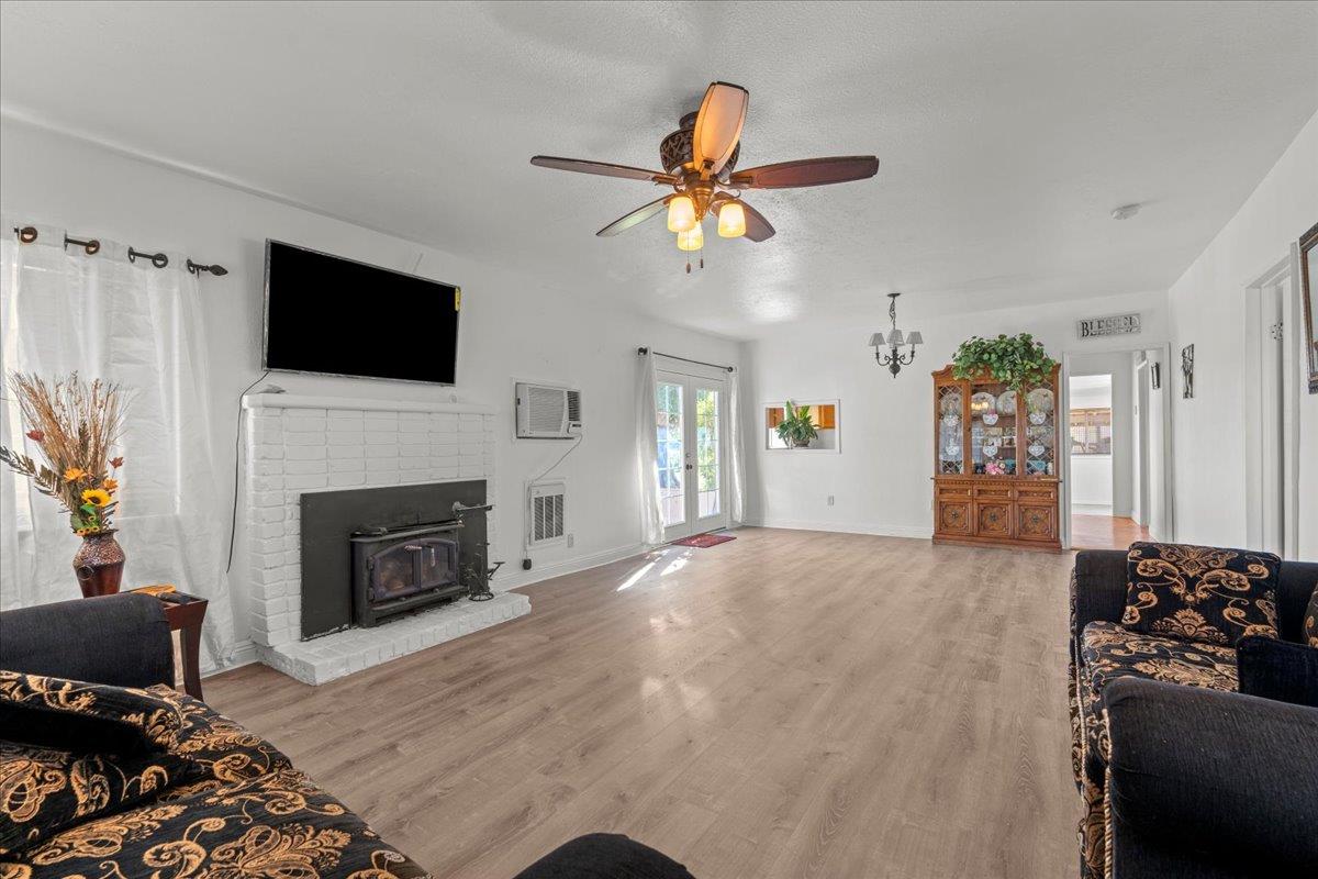 23707 North Graham Road Acampo, CA 95220 - Photo 8 of 37 a living room with furniture a fireplace and a flat screen tv