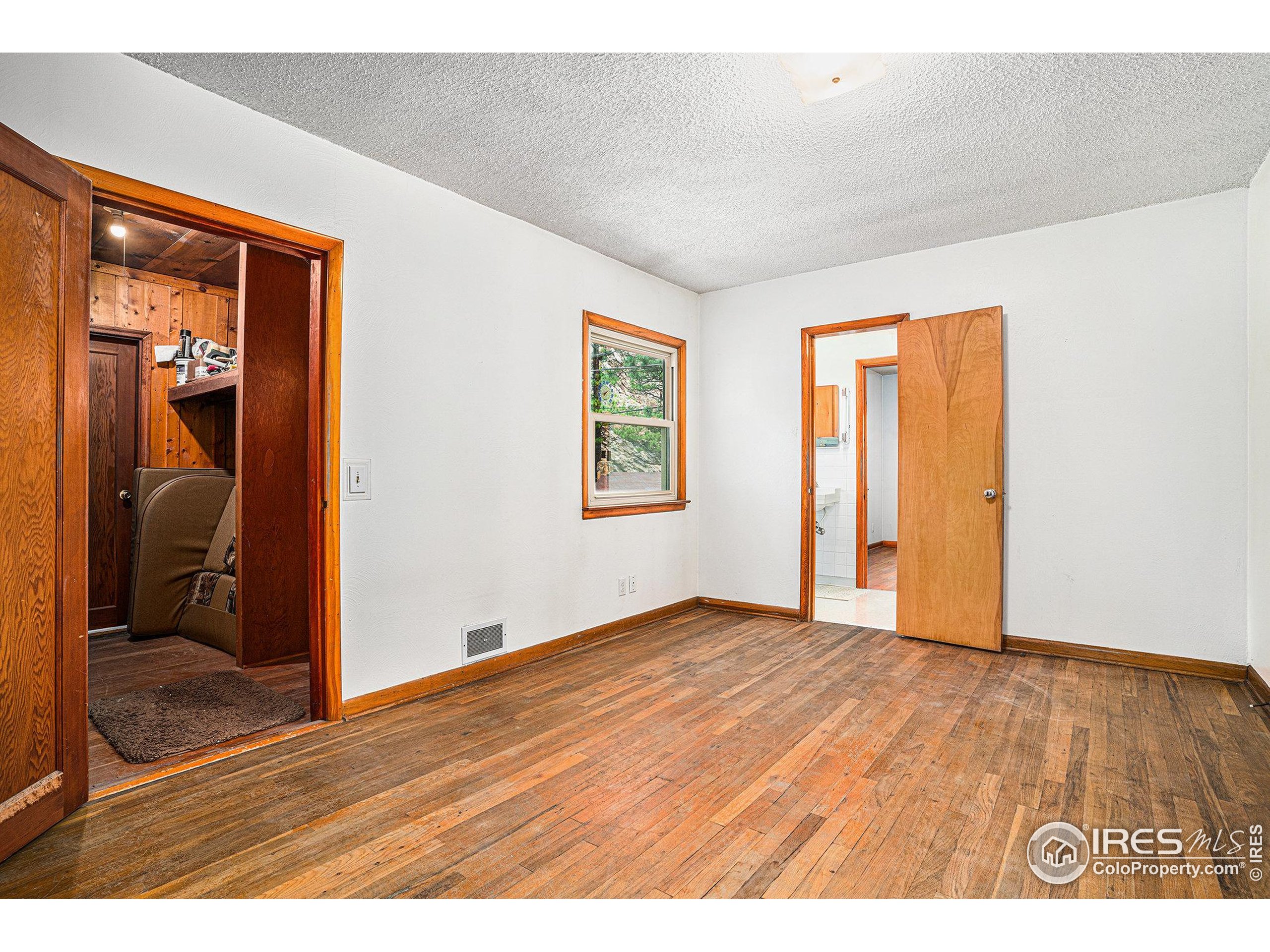 143 Waltonia Road Drake, CO 80515 - Photo 18 of 30 a view of an empty room with wooden floor