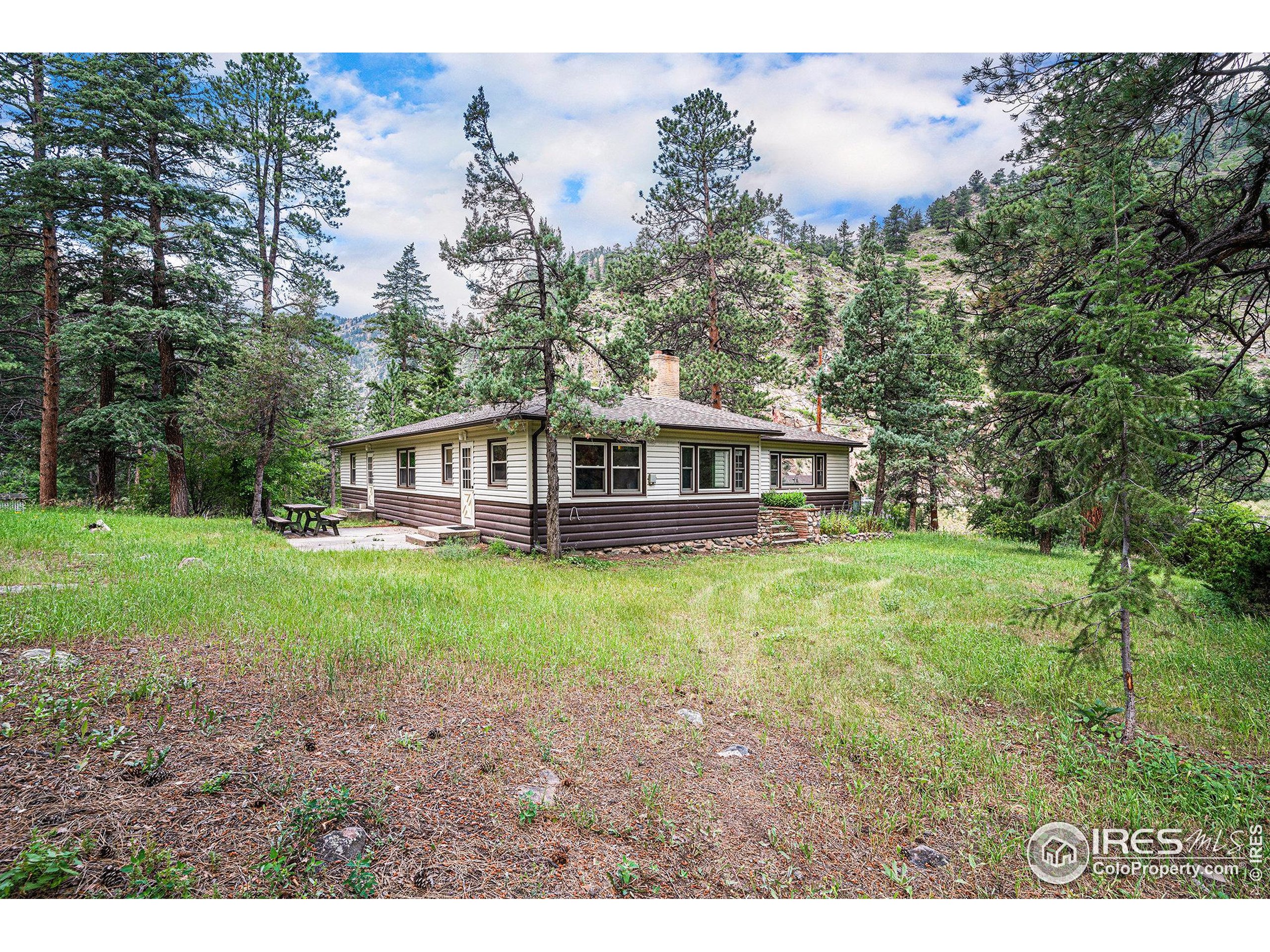 143 Waltonia Road Drake, CO 80515 - Photo 26 of 30 a view of a house with yard and sitting area