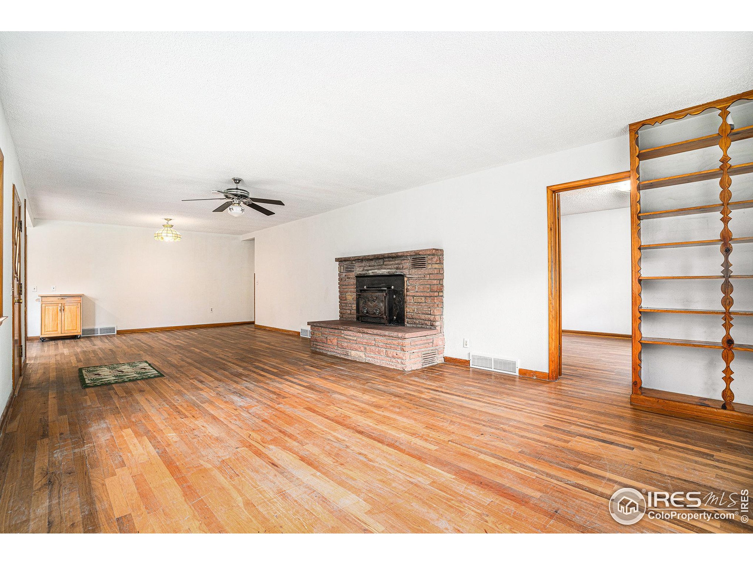 143 Waltonia Road Drake, CO 80515 - Photo 6 of 30 a view of empty room with wooden floor and fan