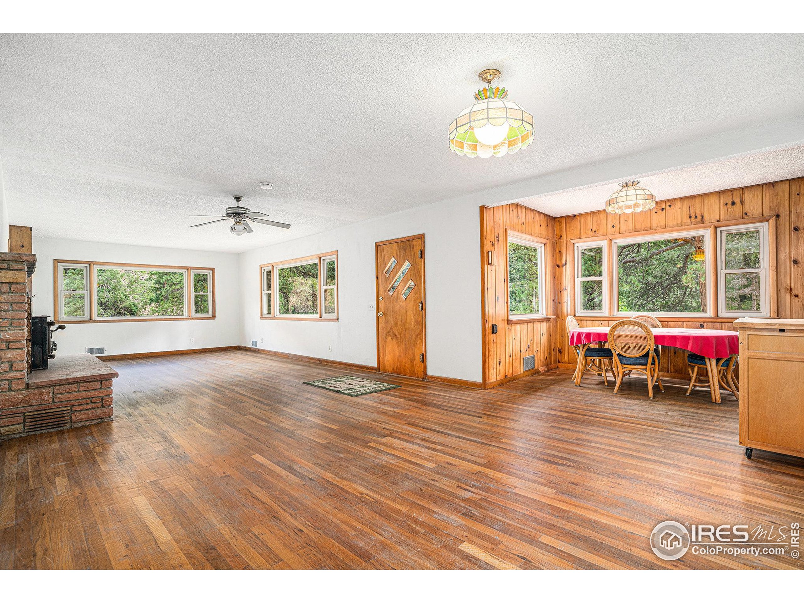 143 Waltonia Road Drake, CO 80515 - Photo 7 of 30 a view of an livingroom with furniture hardwood floor and a ceiling fan