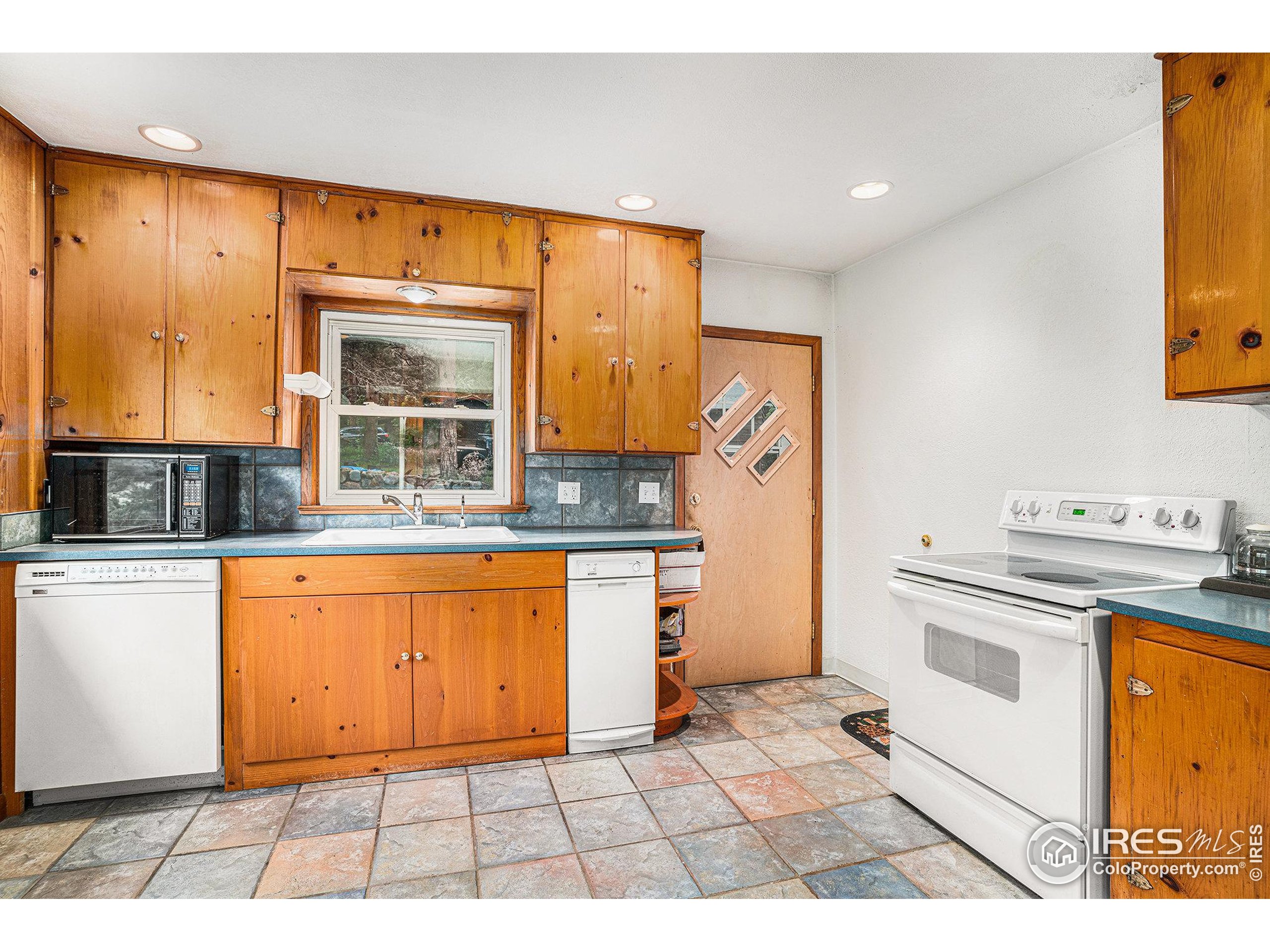 143 Waltonia Road Drake, CO 80515 - Photo 10 of 30 a kitchen with stainless steel appliances granite countertop a stove a sink and a refrigerator