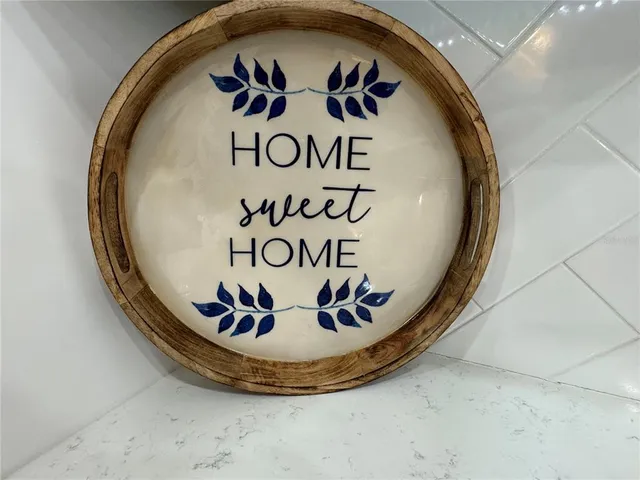 a bedroom with a bed a flat screen tv and a chandelier