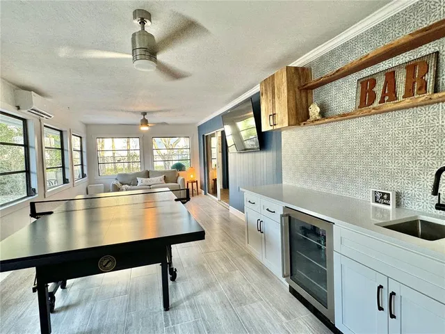 a kitchen with stainless steel appliances granite countertop a sink a stove and cabinets