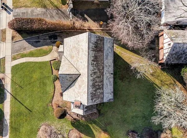 a view of a brick house with a yard