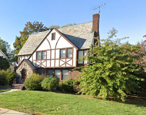 a view of a house with a yard and potted plants