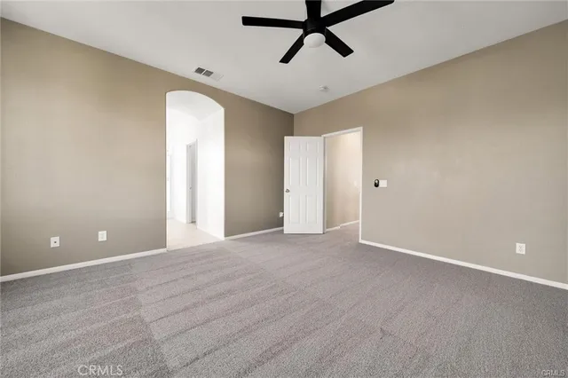 a spacious bathroom with a granite countertop sink a mirror and a bathtub