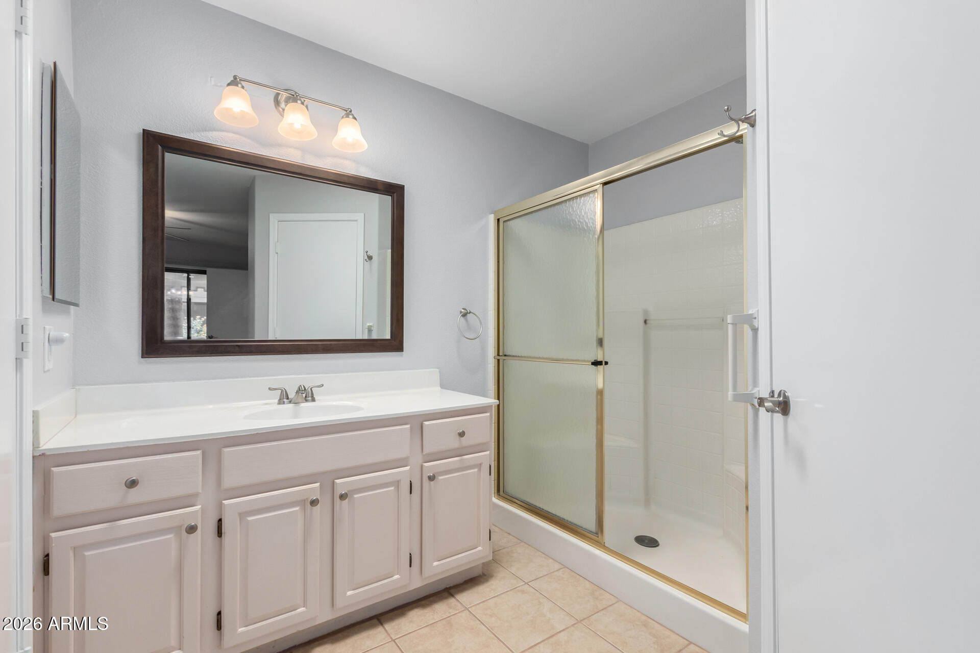 14300 West Bell Road, Unit 349 Surprise, AZ 85374 - Photo 12 of 32 a bathroom with a shower sink and mirror