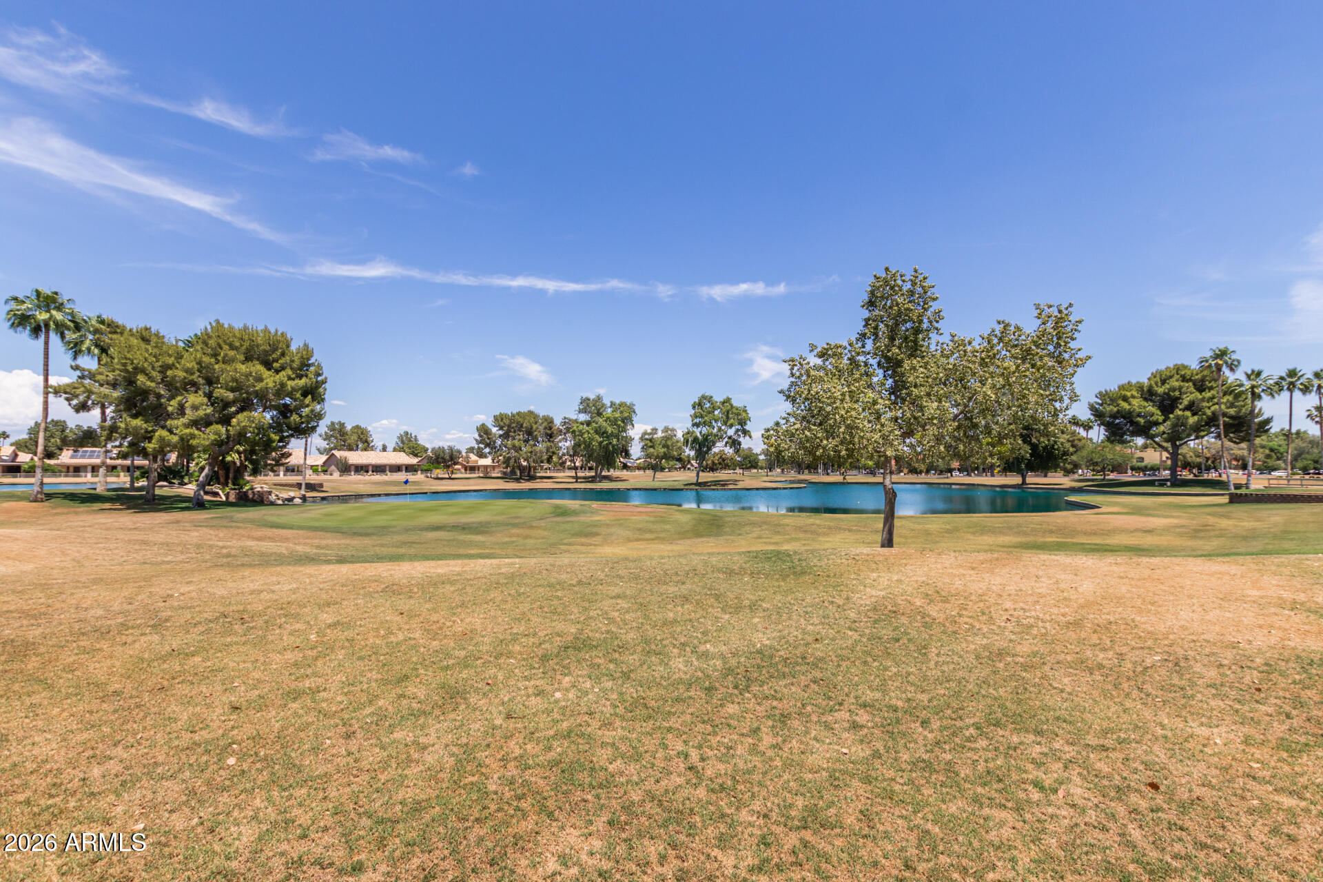 14300 West Bell Road, Unit 349 Surprise, AZ 85374 - Photo 21 of 32 a view of an ocean with a houses in the background