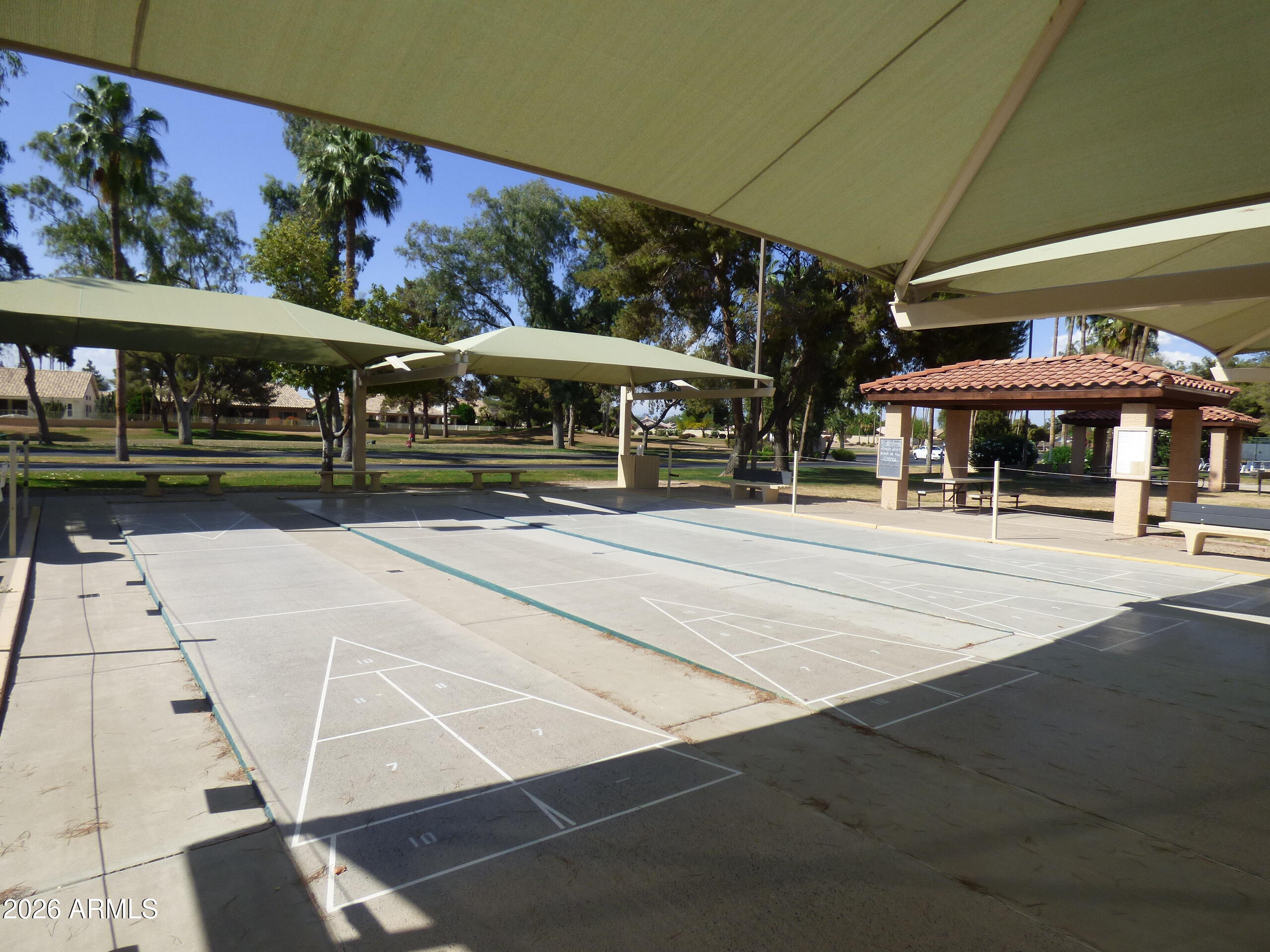 14300 West Bell Road, Unit 349 Surprise, AZ 85374 - Photo 25 of 32 a view of a patio with a table and chairs under an umbrella