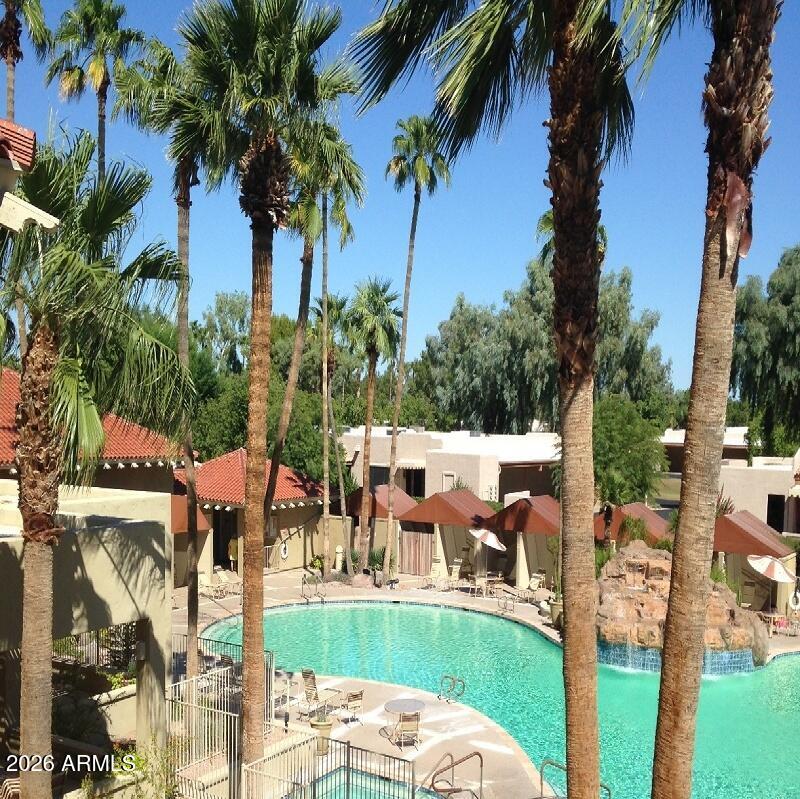 14300 West Bell Road, Unit 349 Surprise, AZ 85374 - Photo 29 of 32 a view of a backyard with swimming pool