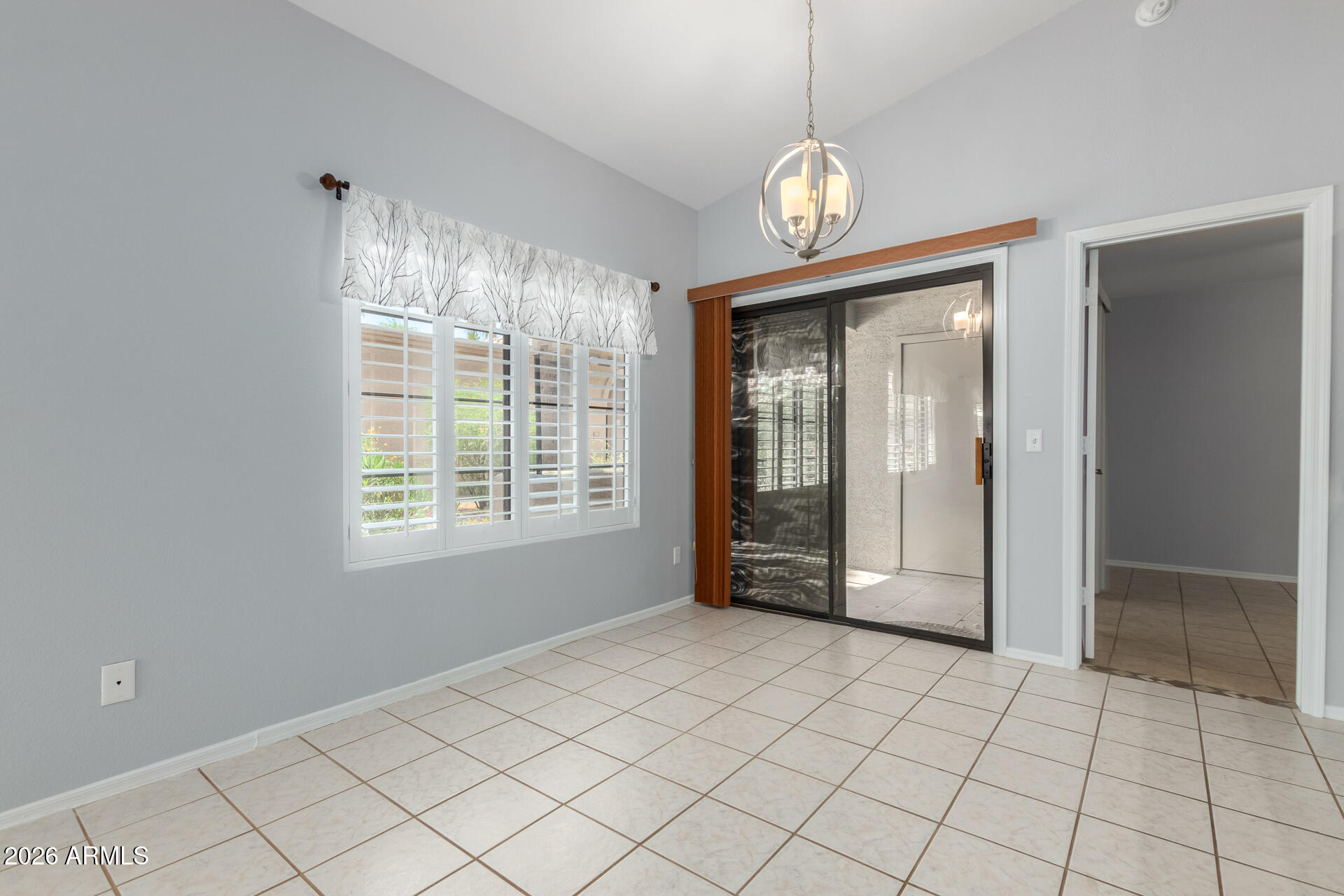 14300 West Bell Road, Unit 349 Surprise, AZ 85374 - Photo 5 of 32 a view of an empty room with window and chandelier fan