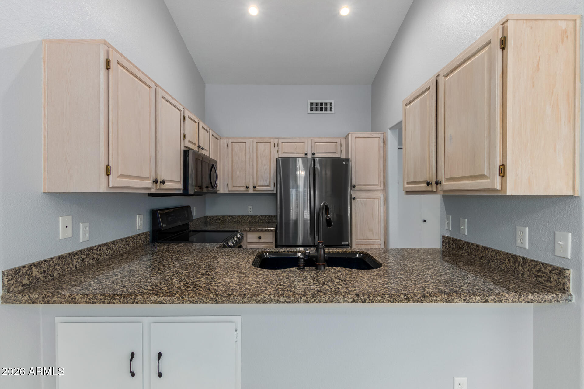 14300 West Bell Road, Unit 349 Surprise, AZ 85374 - Photo 7 of 32 a kitchen with granite countertop a sink a stove and a granite counter top