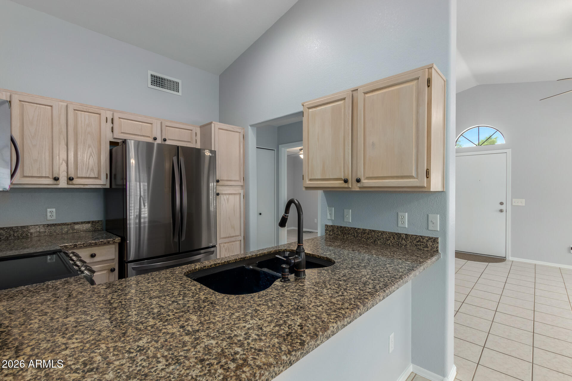 14300 West Bell Road, Unit 349 Surprise, AZ 85374 - Photo 8 of 32 a kitchen with stainless steel appliances granite countertop a sink refrigerator and cabinets