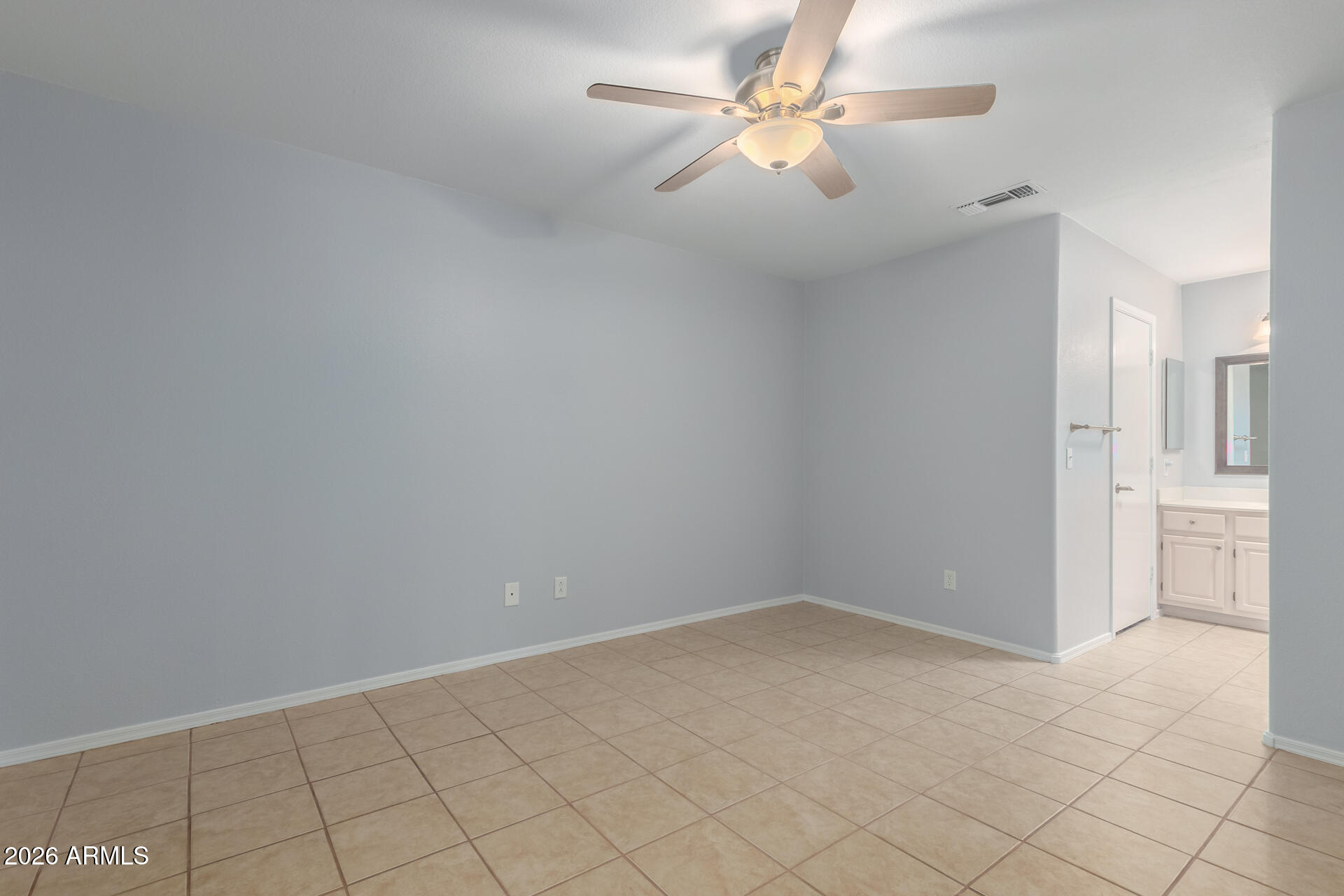14300 West Bell Road, Unit 349 Surprise, AZ 85374 - Photo 9 of 32 an empty room with chandelier fan and windows