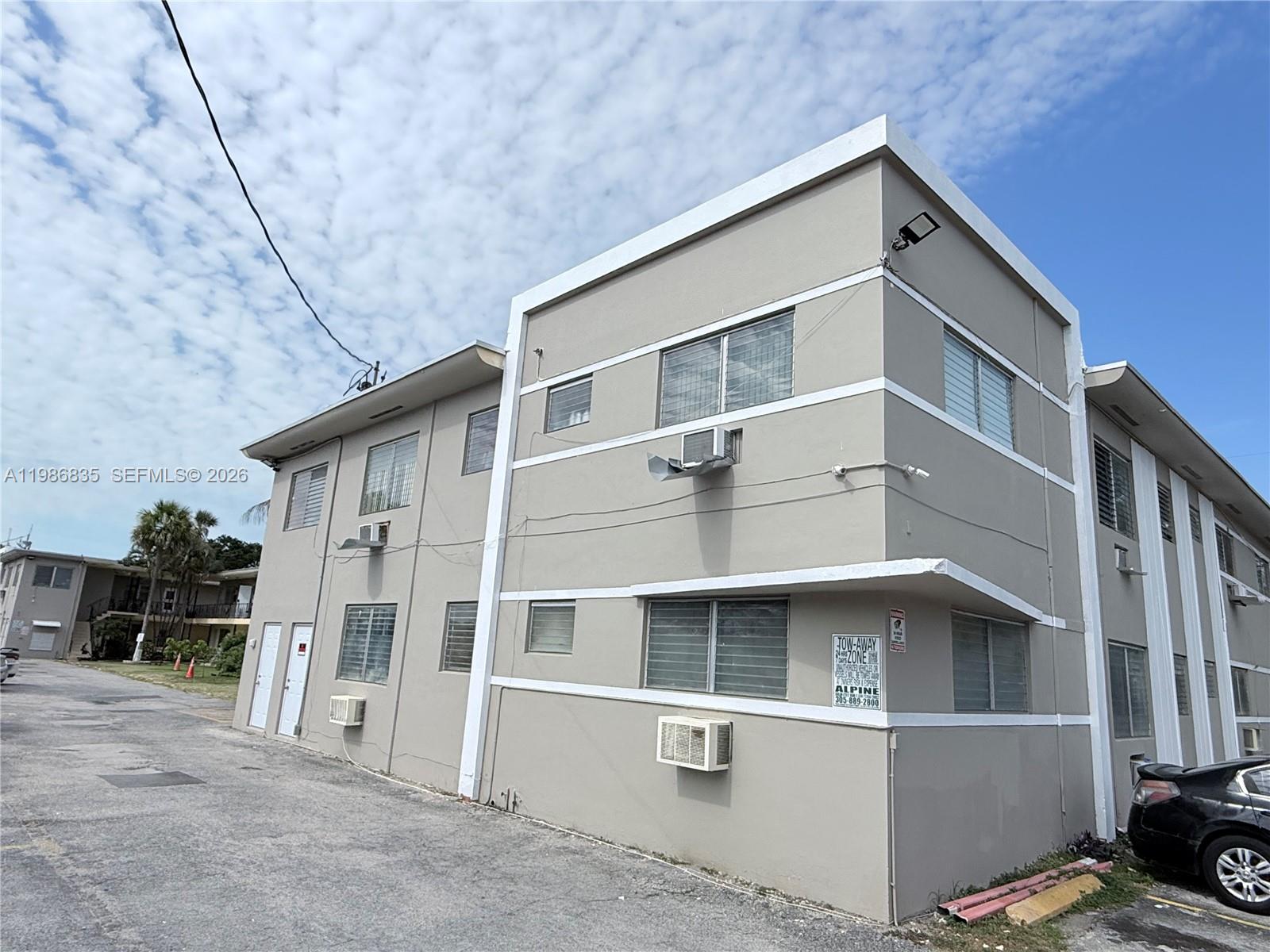 70 Northwest 77th Street, Unit 9 Miami, FL 33150 - Photo 1 of 13 a front view of a house with glass windows and a table